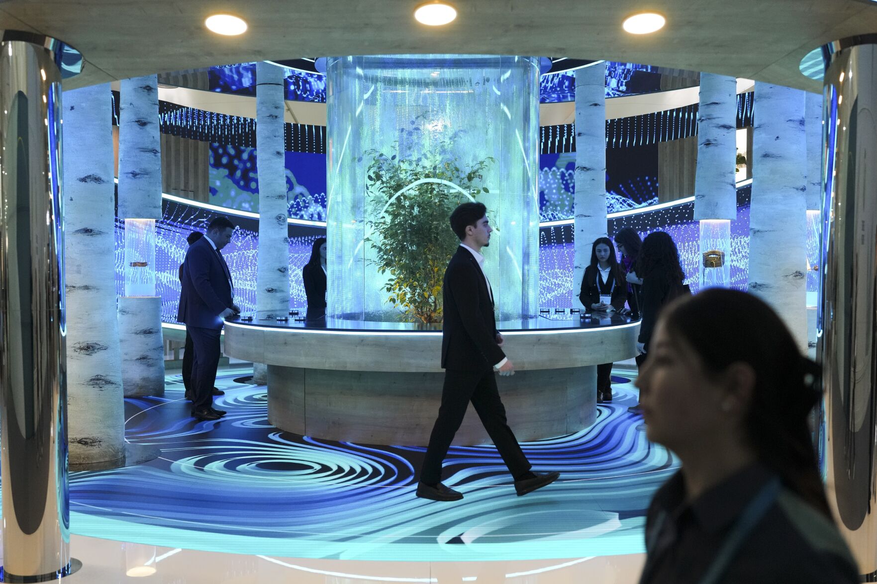 <p>People walk through an exhibit in the Green Zone at the COP29 U.N. Climate Summit, Monday, Nov. 11, 2024, in Baku, Azerbaijan. (AP Photo/Sergei Grits)</p>   PHOTO CREDIT: Sergei Grits 