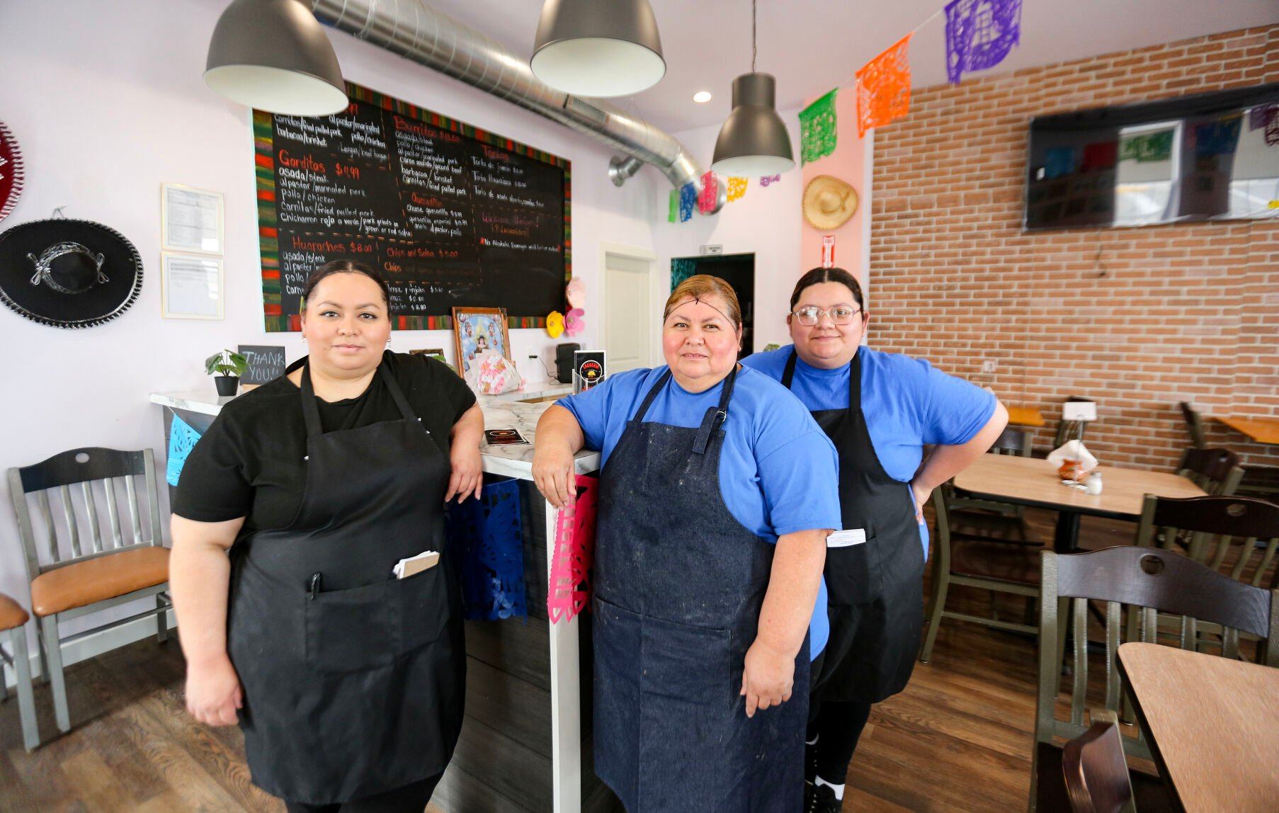 Family members (from left) Brenda Espinoza-Lopez, Alicia Lopez and Valeria Espinoza, have opened Taquería Monterrey in Dyersville, Iowa.    PHOTO CREDIT: Dave Kettering