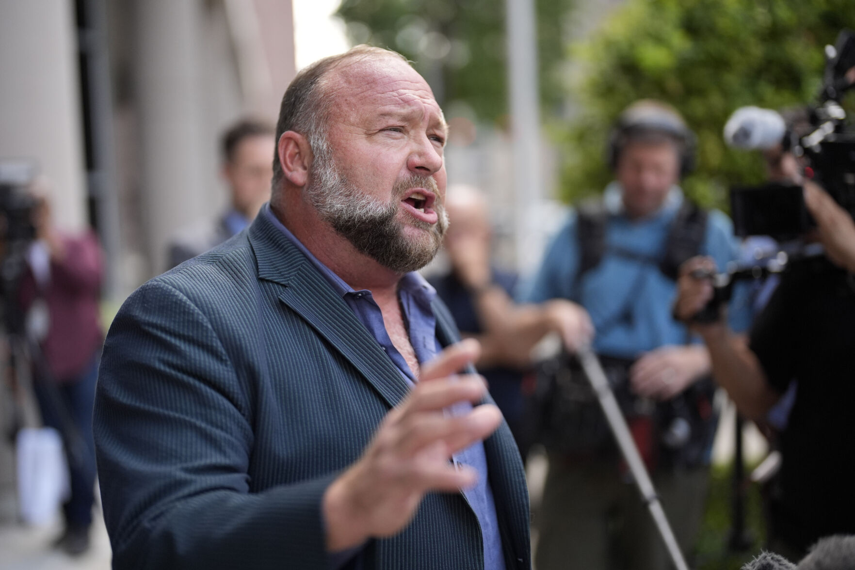 <p>FILE - Right-wing conspiracy theorist Alex Jones speaks to the media after arriving at the federal courthouse for a hearing in front of a bankruptcy judge, Friday, June 14, 2024, in Houston. (AP Photo/David J. Phillip, File)</p>   PHOTO CREDIT: David J. Phillip 