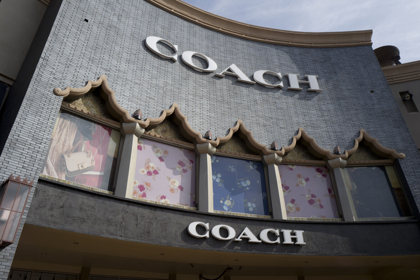 <p>FILE - A chain of the Coach brand, owned by parent company Tapestry, is seen, May 3, 2019, at the Citadel Outlets in Commerce, Calif. (AP Photo/Richard Vogel, File)</p>   PHOTO CREDIT: Richard Vogel 