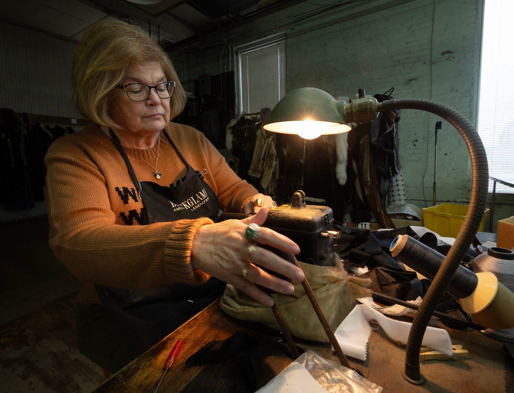 Master furrier Jane Deutmeyer sews at Rhomberg