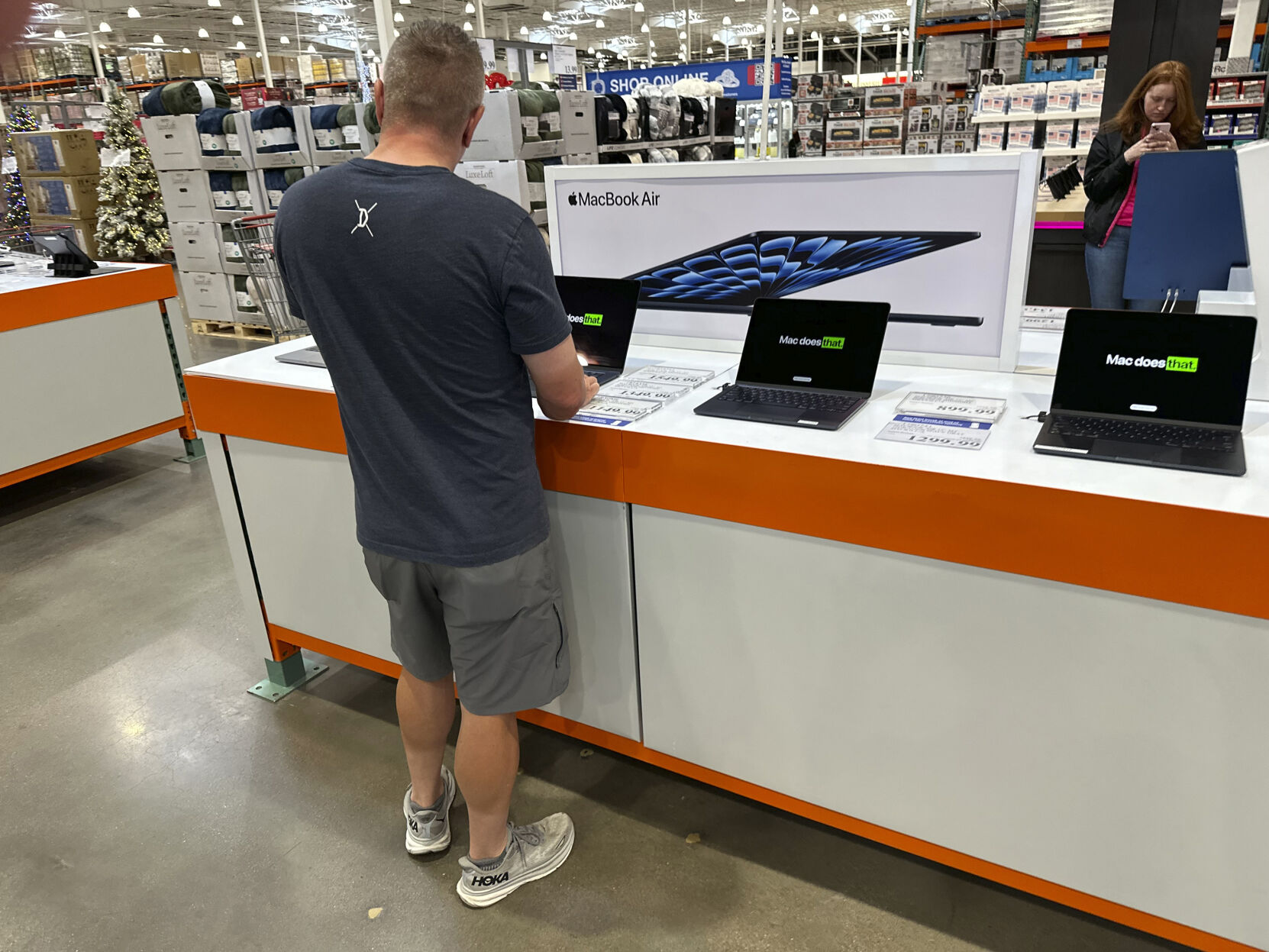 <p>FILE - A shopper considers a MacBook Air on display in a Costco warehouse on Sept. 19, 2024, in Lone Tree, Colo. (AP Photo/David Zalubowski, File)</p>   PHOTO CREDIT: David Zalubowski - staff, ASSOCIATED PRESS