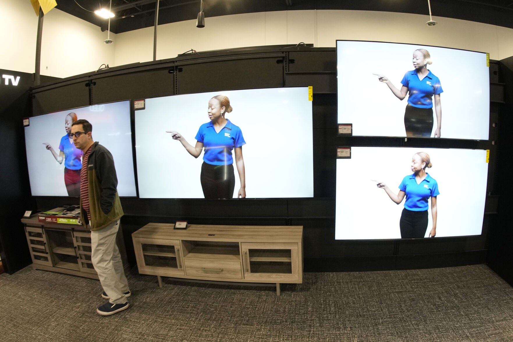 <p>FILE - A customer turns away after looking at big-screen televisions in a Best Buy store Nov. 21, 2023, in southeast Denver. (AP Photo/David Zalubowski, File)</p>   PHOTO CREDIT: David Zalubowski - staff, ASSOCIATED PRESS