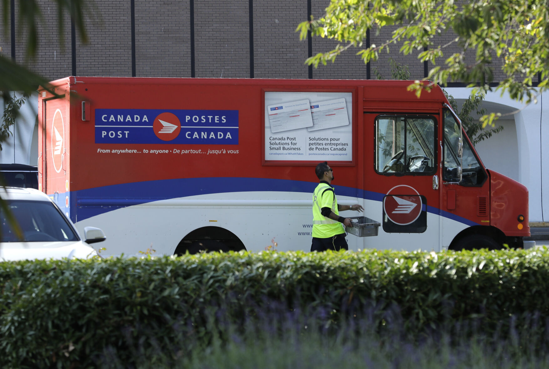 <p>FILE -A Canada Post worker walks to his truck on Sept. 26, 2018 in Richmond, British Columbia. (AP Photo/Ted S. Warren, File)</p>   PHOTO CREDIT: Ted S. Warren - staff, ASSOCIATED PRESS