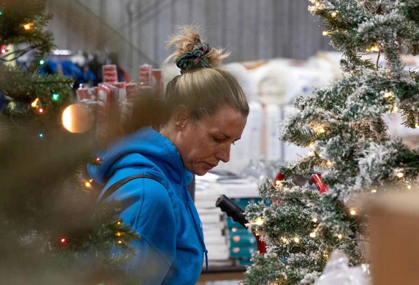 Sara Oglesby shops for a Christmas tree at Triple J Liquidation in Dubuque on Friday, Nov. 15, 2024.    PHOTO CREDIT: Stephen Gassman