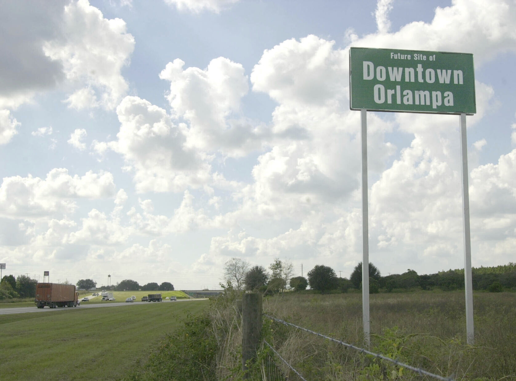 <p>FILE - A tongue-in-cheek sign referencing what someday might be the heart of the sprawling metro areas of Orlando and Tampa is seen, installed by a private landowner, along Interstate 4 in Polk City, Fla., Oct. 24, 2002. (AP Photo/Peter Cosgrove, File)</p>   PHOTO CREDIT: Peter Cosgrove - staff, ASSOCIATED PRESS