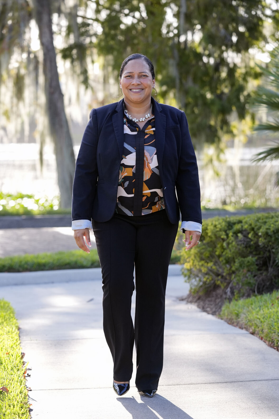 <p>Marisol Ortega, a Polk County resident that commutes to her job in Orlando walks at a park Thursday, Nov. 14, 2024, in Orlando, Fla. (AP Photo/John Raoux)</p>   PHOTO CREDIT: John Raoux - staff, ASSOCIATED PRESS