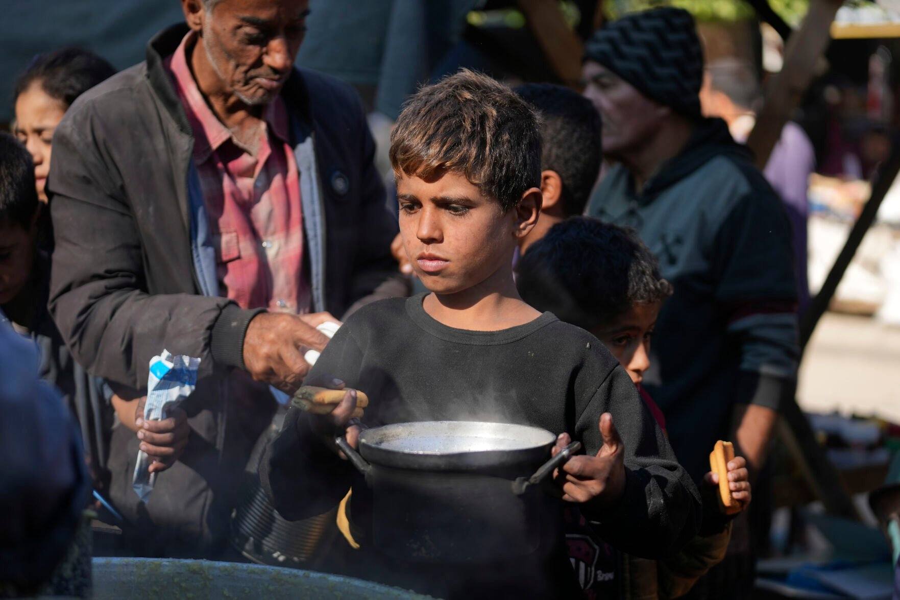 <p>A Palestinian child queues for food in Deir al-Balah, Gaza Strip, Monday, Nov. 18, 2024. (AP Photo/Abdel Kareem Hana)</p>   PHOTO CREDIT: Abdel Kareem Hana 