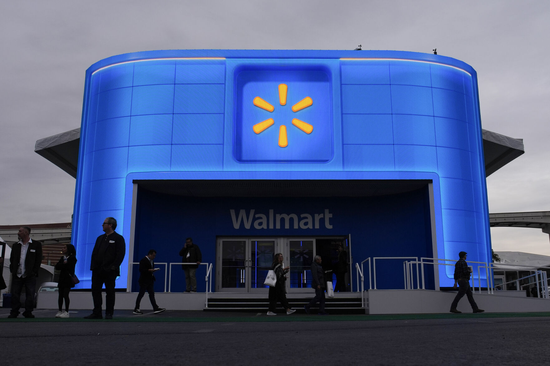 <p>FILE - People walk by the Walmart booth during the CES tech show on Jan. 9, 2024, in Las Vegas. (AP Photo/John Locher, File)</p>   PHOTO CREDIT: John Locher 