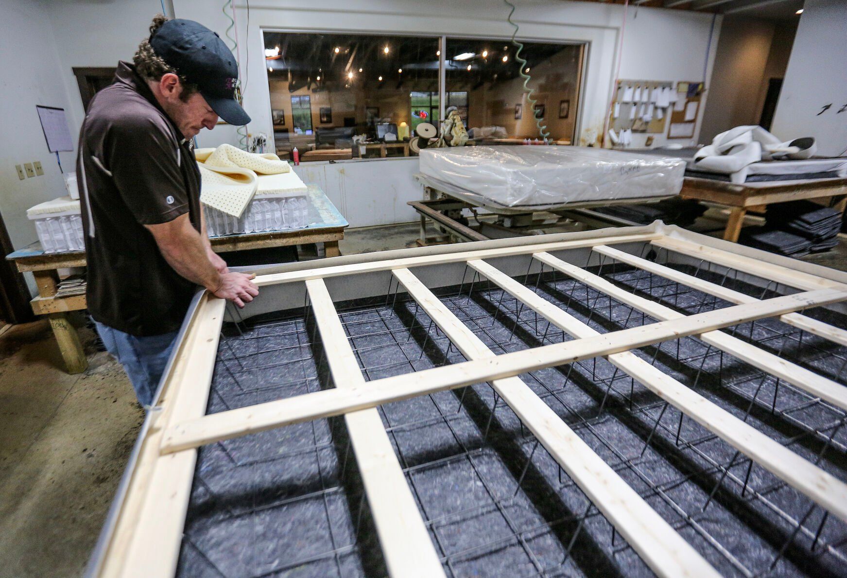 Jordan Sumners works on a building a custom mattress at Dubuque Mattress Factory.    PHOTO CREDIT: Dave Kettering
Telegraph Herald