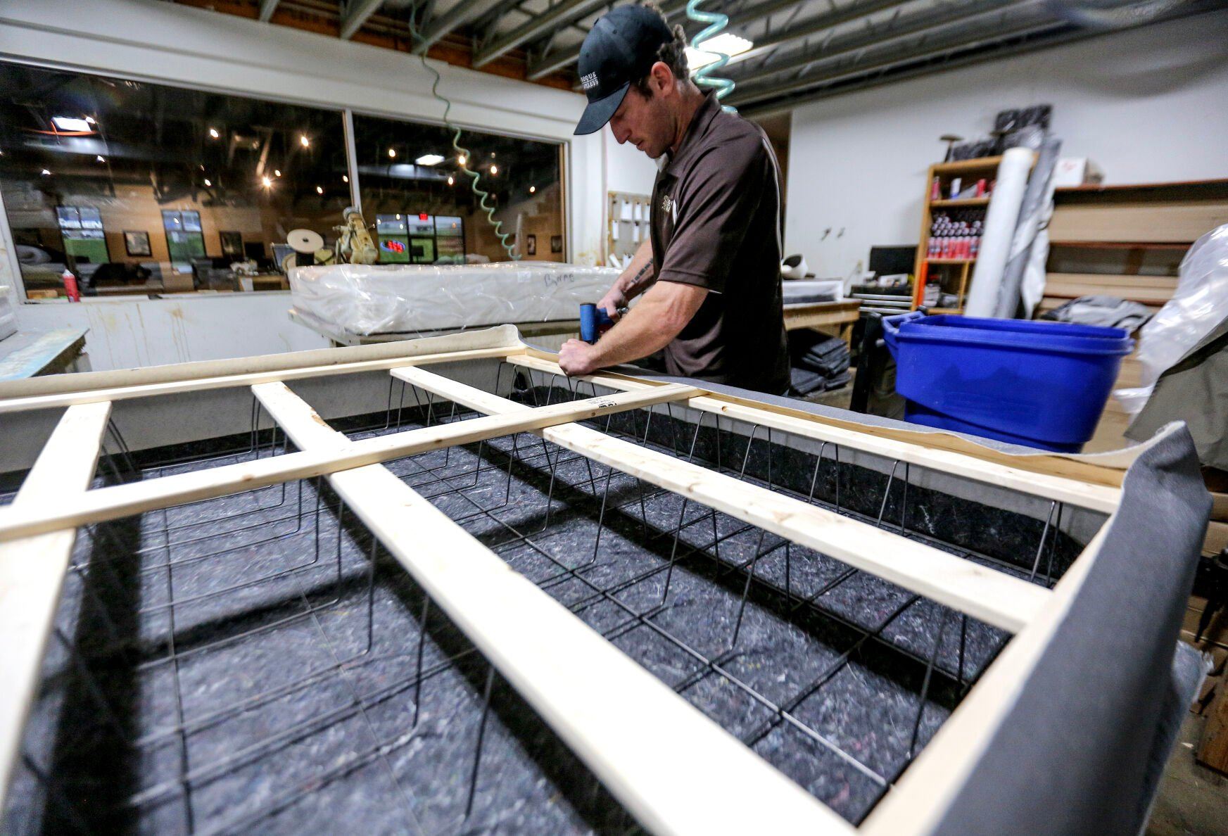 Jordan Sumners builds a mattress at Dubuque Mattress Factory.    PHOTO CREDIT: Dave Kettering
Telegraph Herald