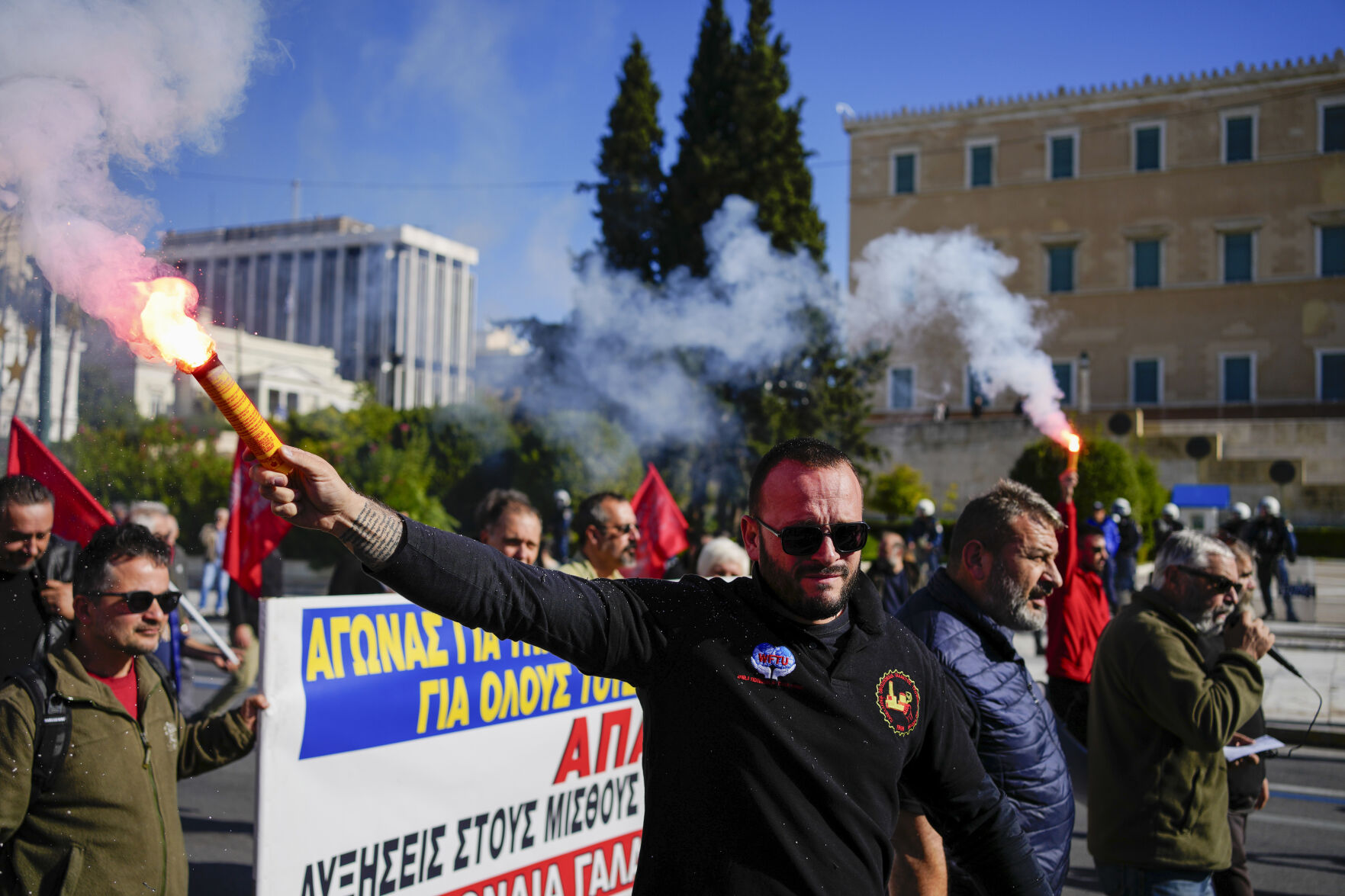 <p>Protesters hold flares as they take part in rally, during a nationwide general strike organized by private and public sector unions demanding for better wages, in Athens, Greece, Wednesday, Nov. 20, 2024. (AP Photo/Thanassis Stavrakis)</p>   PHOTO CREDIT: Thanassis Stavrakis - staff, ASSOCIATED PRESS