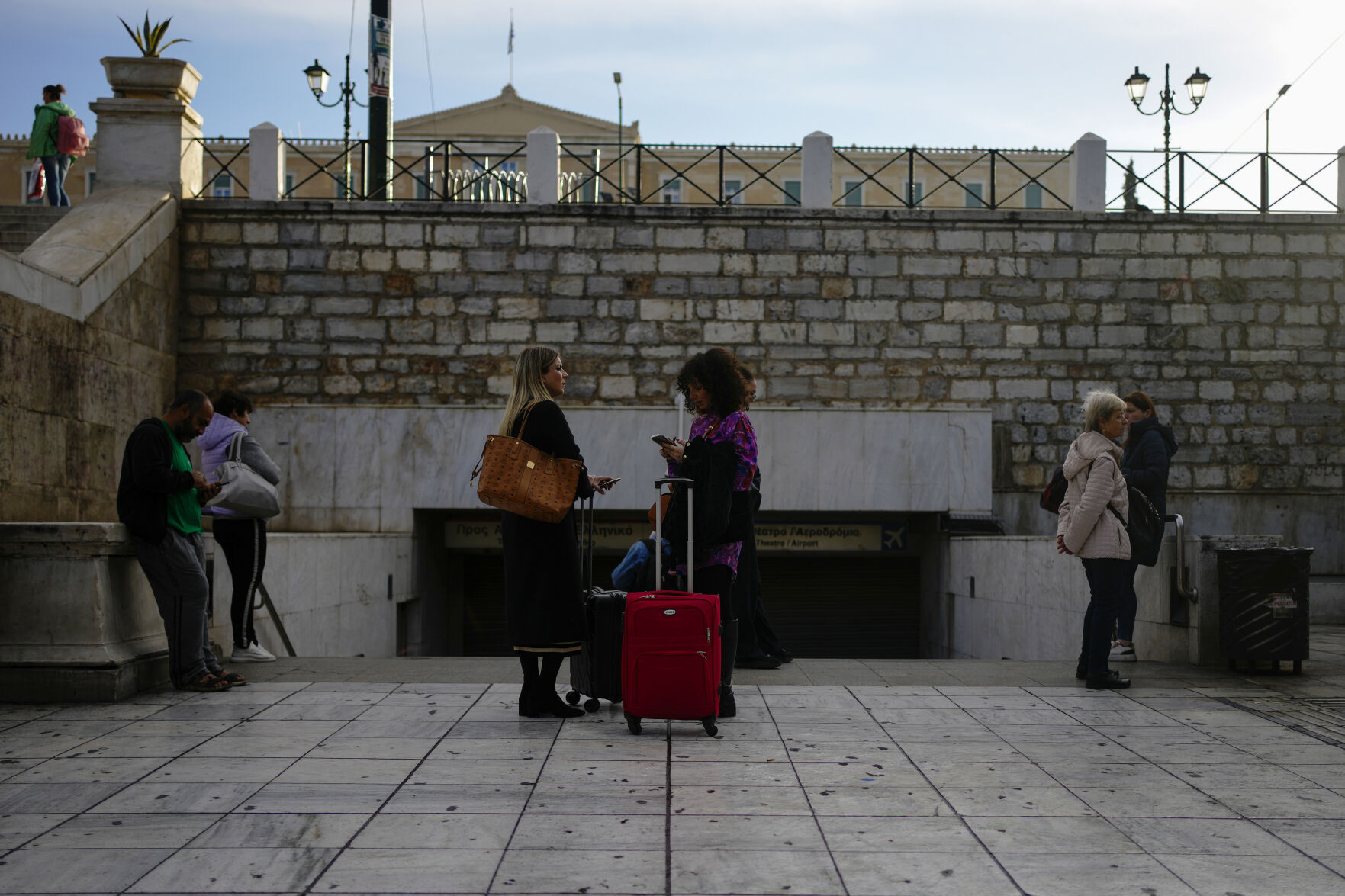 <p>Commuters stand outside the closed main metro Syntagma station, during a nationwide general strike organized by private and public sector unions demanding for better wages, in Athens, Greece, Wednesday, Nov. 20, 2024. (AP Photo/Thanassis Stavrakis)</p>   PHOTO CREDIT: Thanassis Stavrakis - staff, ASSOCIATED PRESS