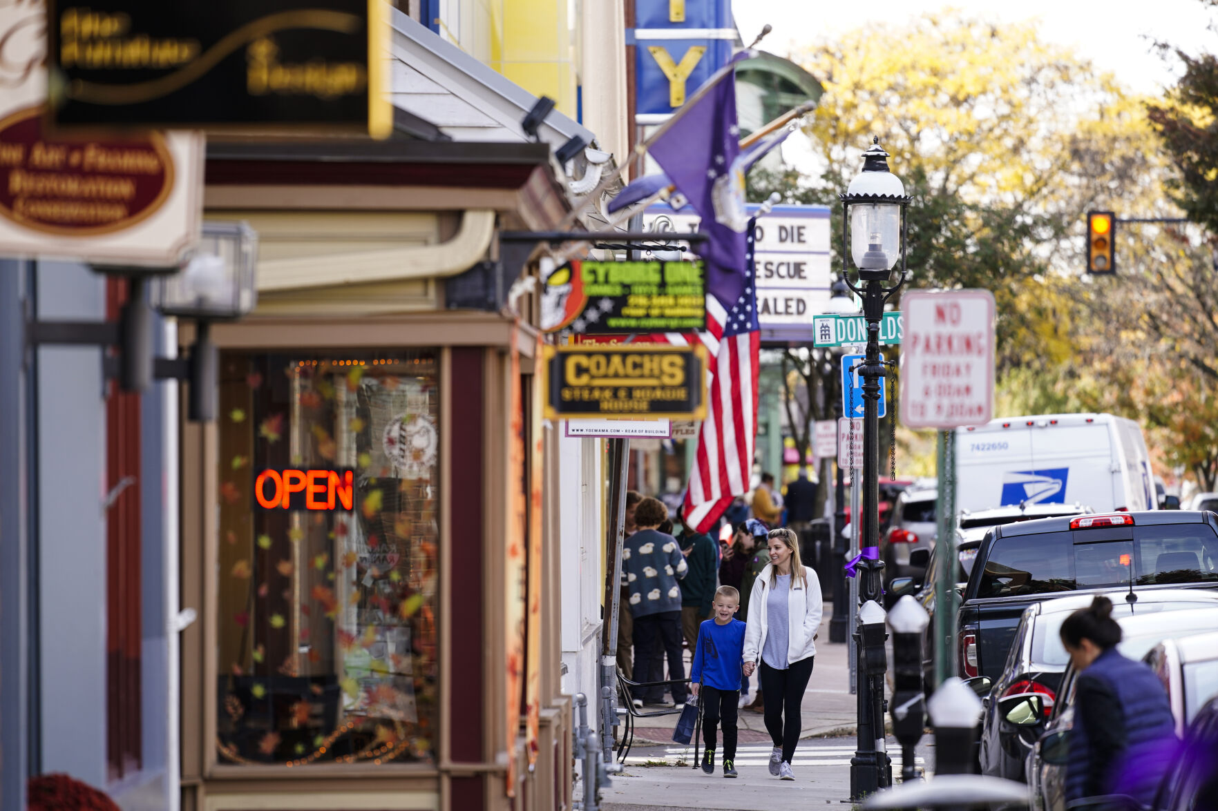 <p>FILE - People walk past small businesses in Doylestown, Pa., Nov. 4, 2021. (AP Photo/Matt Rourke, File)</p>   PHOTO CREDIT: Matt Rourke 