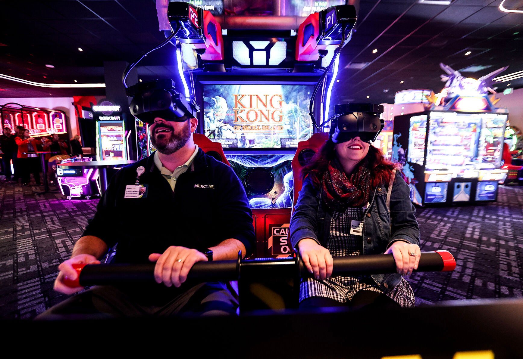 David Moore (left) and Maddy Marty, both with MercyOne Foundation, play one of the virtual video games at Island Social inside Q Casino + Resort on Tuesday. The family fun center opens to the public on Wednesday, Nov. 27.    PHOTO CREDIT: Dave Kettering