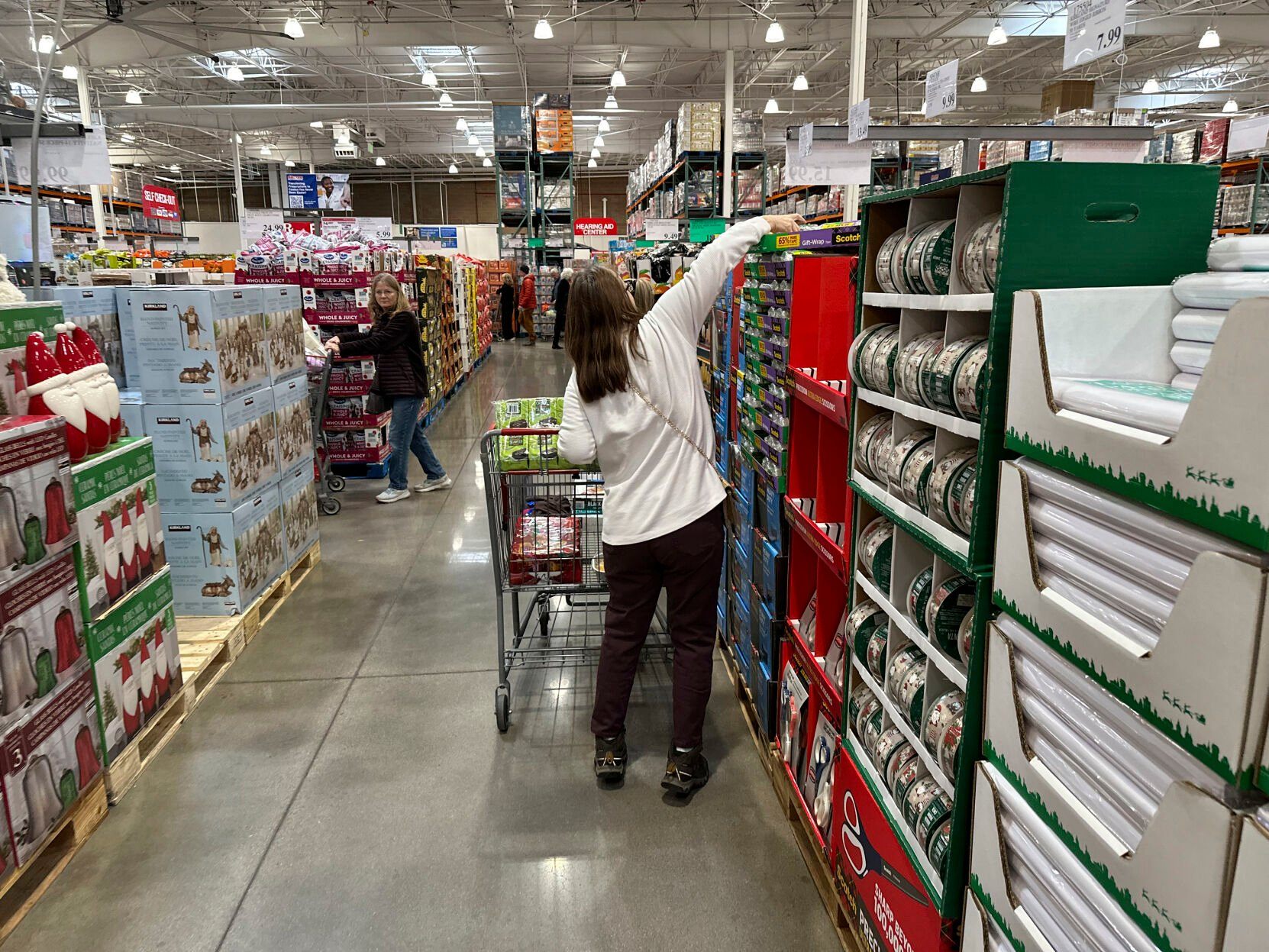 <p>FILE - Shoppers reach for items on display in a Costco warehouse Nov. 19, 2024, in Lone Tree, Colo. (AP Photo/David Zalubowski, File)</p>   PHOTO CREDIT: David Zalubowski - staff, ASSOCIATED PRESS