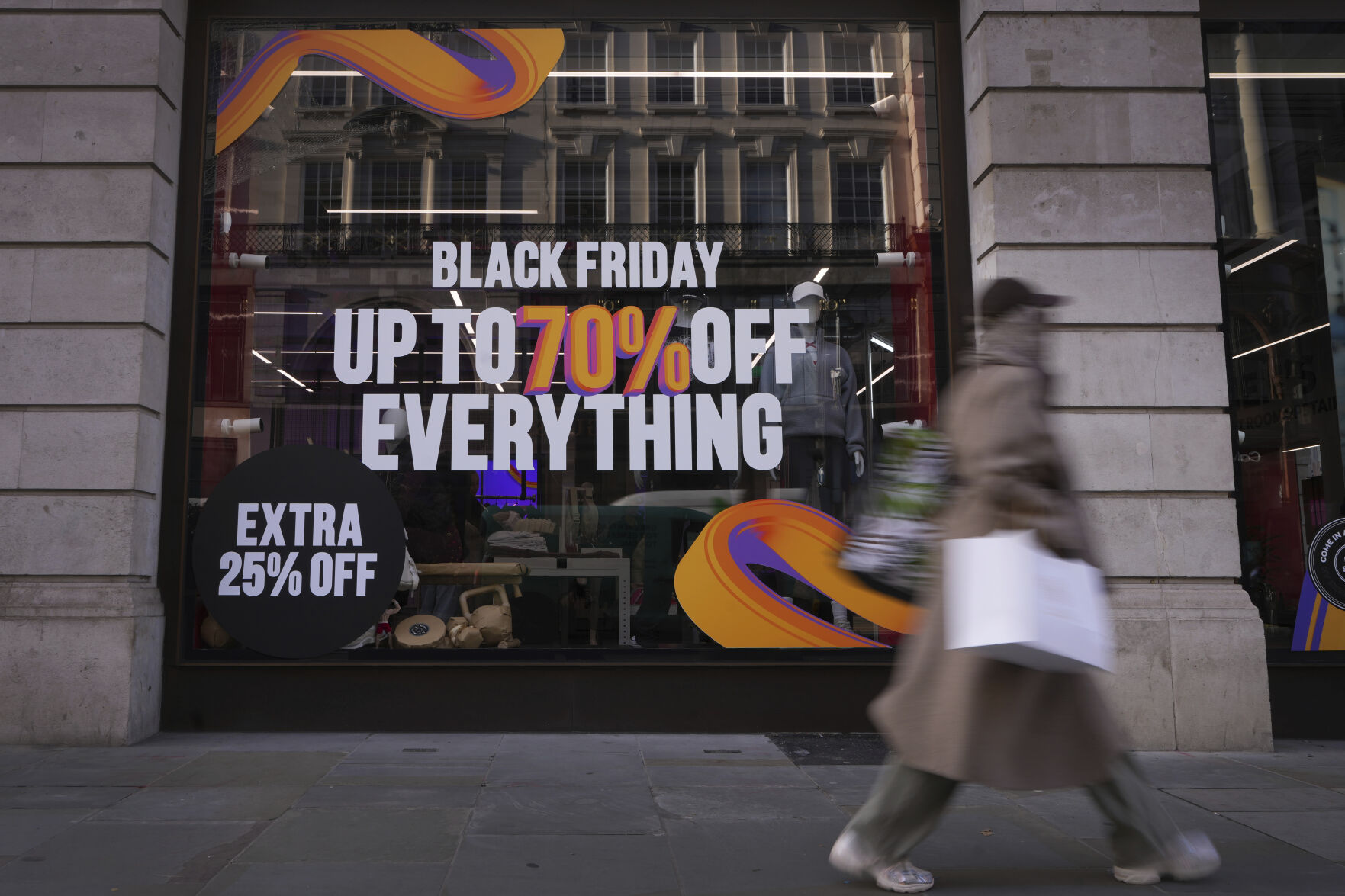 <p>A shopper passes a store advertising a Black Friday Sale on Regent Street in London, Thursday, Nov. 28, 2024. (AP Photo/Kirsty Wigglesworth)</p>   PHOTO CREDIT: Kirsty Wigglesworth - staff, ASSOCIATED PRESS