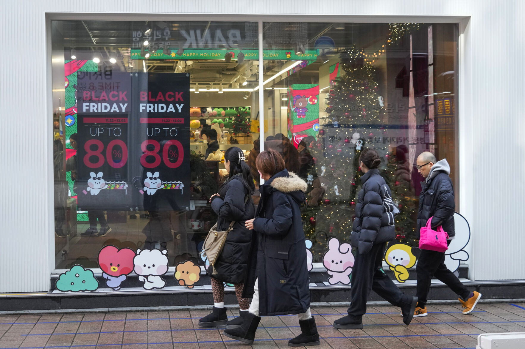 <p>People walk by sale signs on the shopping street in Seoul, South Korea, Thursday, Nov. 28, 2024.(AP Photo/Ahn Young-joon)</p>   PHOTO CREDIT: Ahn Young-joon - staff, ASSOCIATED PRESS