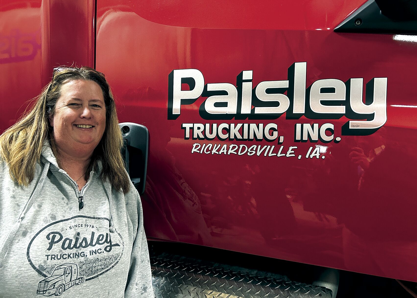 Kim Paisley McDermott, president of Paisley Trucking, poses next to a truck at the company in Rickardsville, Iowa.    PHOTO CREDIT: Erik Hogstrom
