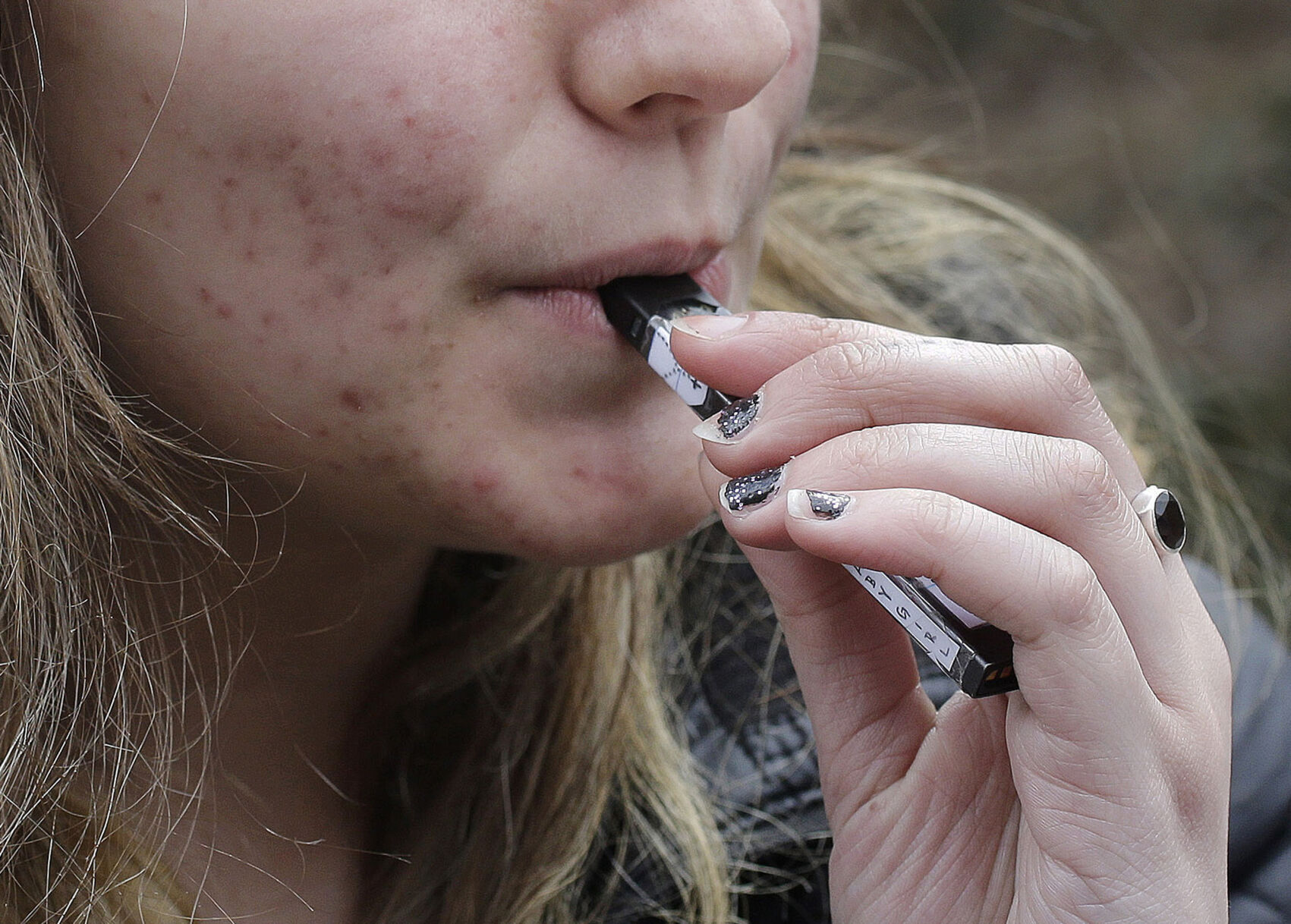 <p>FILE - A high school student uses a vaping device near a school campus in Cambridge, Mass., April 11, 2018. (AP Photo/Steven Senne, File)</p>   PHOTO CREDIT: Steven Senne 