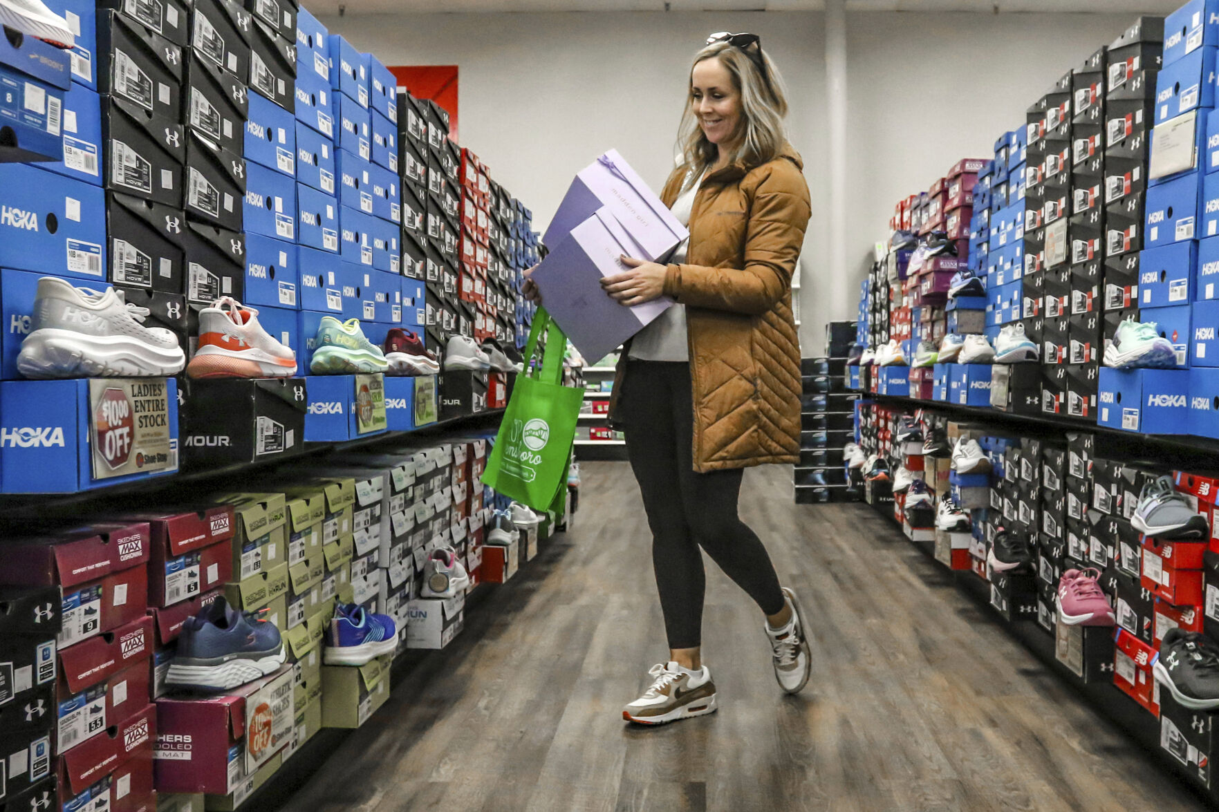 <p>FILE - Ashley Crafton looks at tennis shoes at at Shoe Stop while shopping during Small Business Saturday in Wesleyan Park Plaza on Nov. 25, 2023, in Owensboro, Ky. (Greg Eans/The Messenger-Inquirer via AP, File)</p>   PHOTO CREDIT: Greg Eans - member image share, ASSOCIATED PRESS