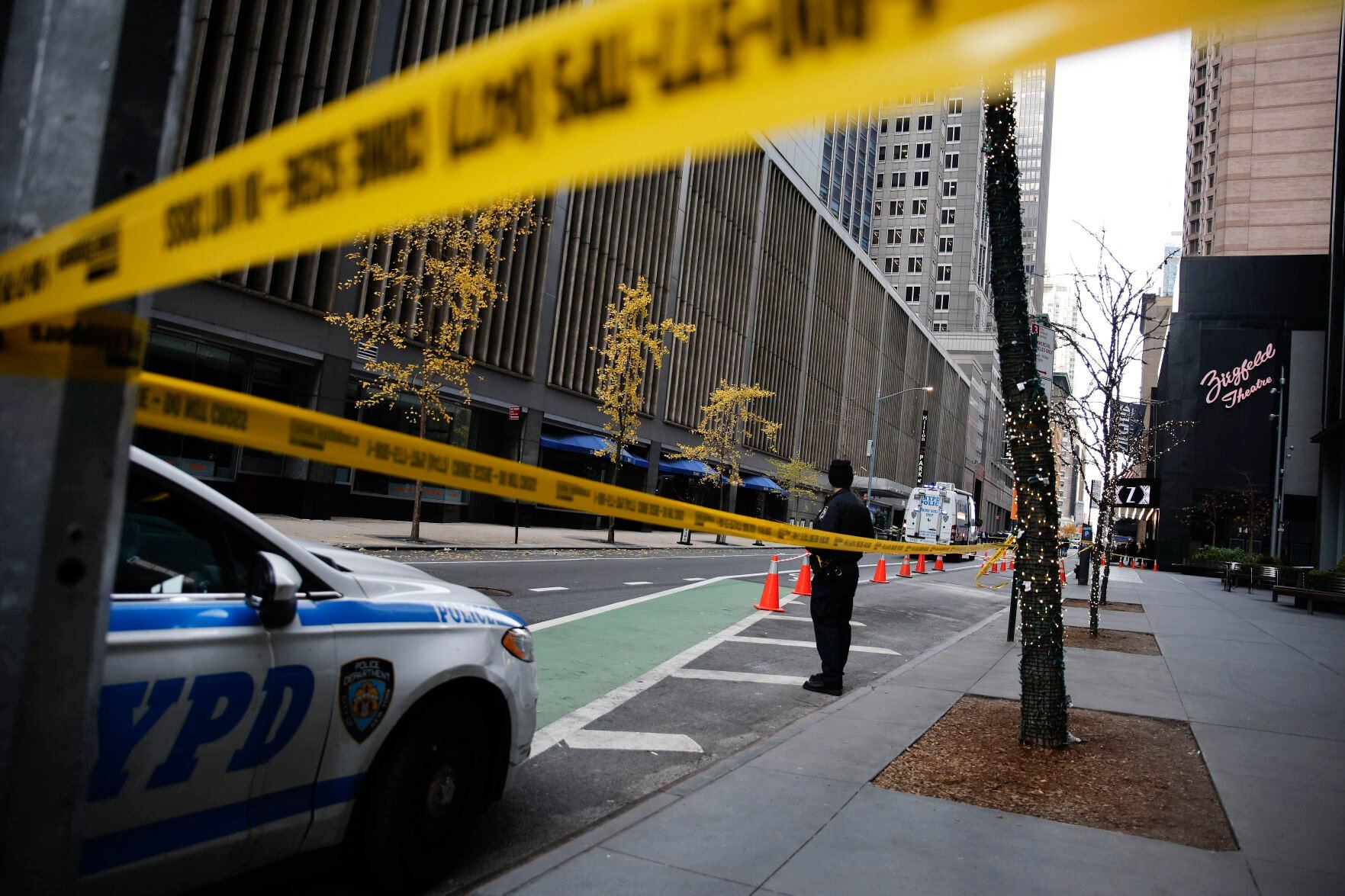 <p>A New York police officer stands on 54th Street outside the Hilton Hotel in midtown Manhattan where Brian Thompson, the CEO of UnitedHealthcare, was fatally shot Wednesday, Dec. 4, 2024, in New York. (AP Photo/Stefan Jeremiah)</p>   PHOTO CREDIT: Stefan Jeremiah - freelancer, ASSOCIATED PRESS