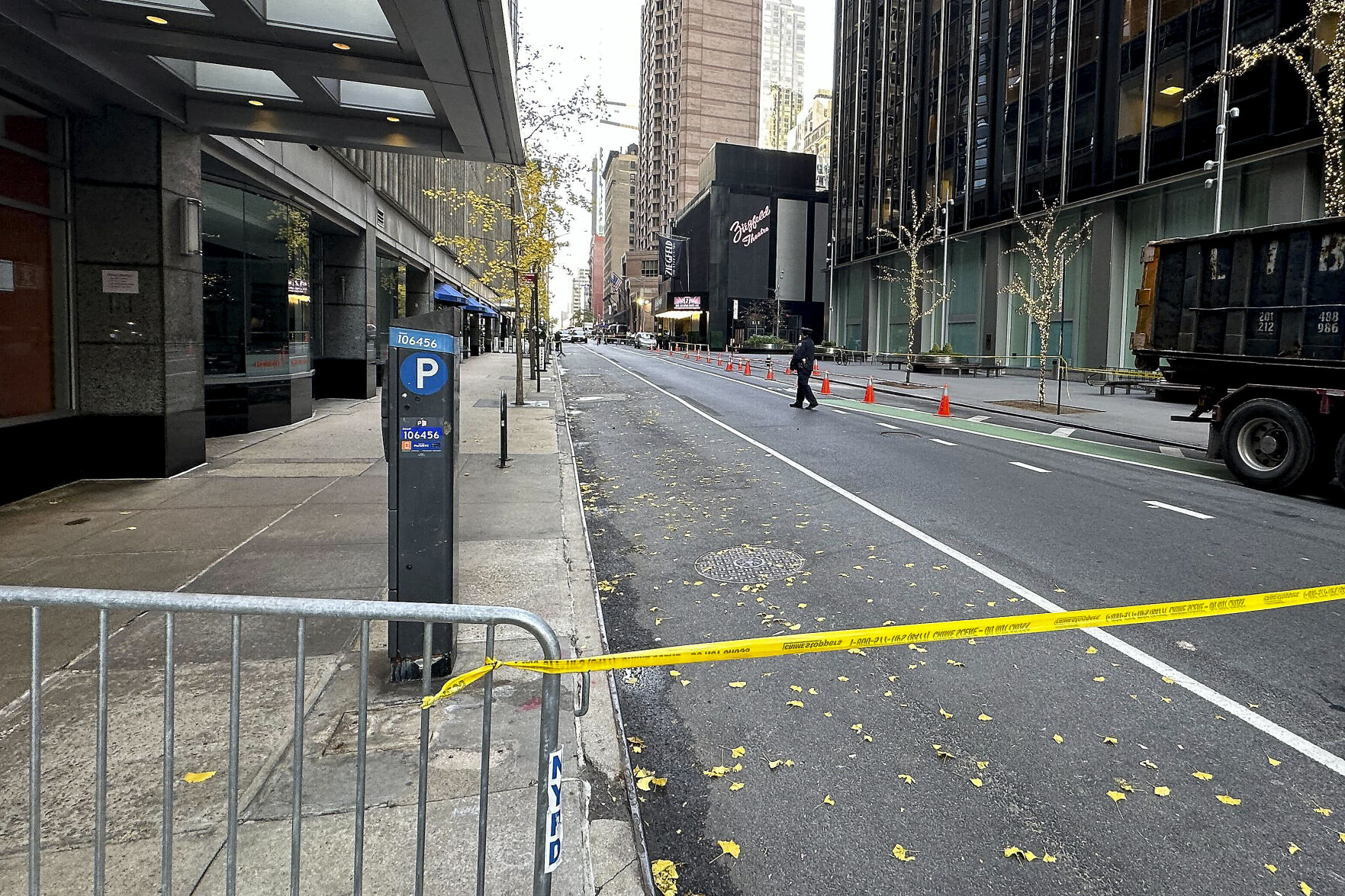 <p>A New York police officer walks outside a hotel in midtown Manhattan where Brian Thompson, the CEO of UnitedHealthcare, was fatally shot Wednesday, Wednesday, Dec. 4, 2024, in New York. (AP Photo/Joe Frederick)</p>   PHOTO CREDIT: Joe Frederick - staff, ASSOCIATED PRESS