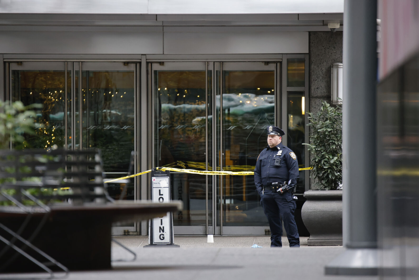 <p>A New York police officer stands outside the Hilton Hotel in midtown Manhattan where Brian Thompson, the CEO of UnitedHealthcare, was fatally shot Wednesday, Wednesday, Dec. 4, 2024, in New York. (AP Photo/Stefan Jeremiah)</p>   PHOTO CREDIT: Stefan Jeremiah - freelancer, ASSOCIATED PRESS