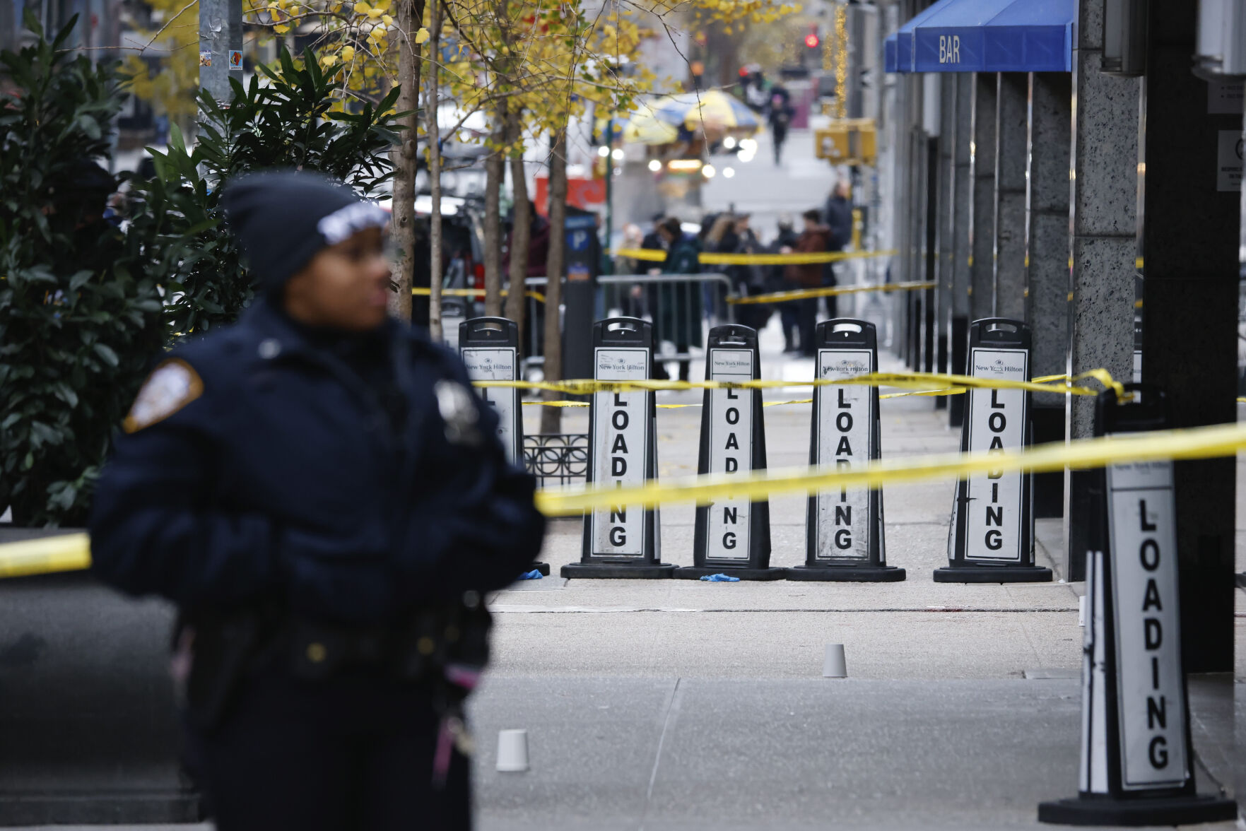 <p>A New York police officer stands outside the Hilton Hotel in midtown Manhattan where Brian Thompson, the CEO of UnitedHealthcare, was fatally shot, Wednesday, Dec. 4, 2024, in New York. (AP Photo/Stefan Jeremiah)</p>   PHOTO CREDIT: Stefan Jeremiah - freelancer, ASSOCIATED PRESS