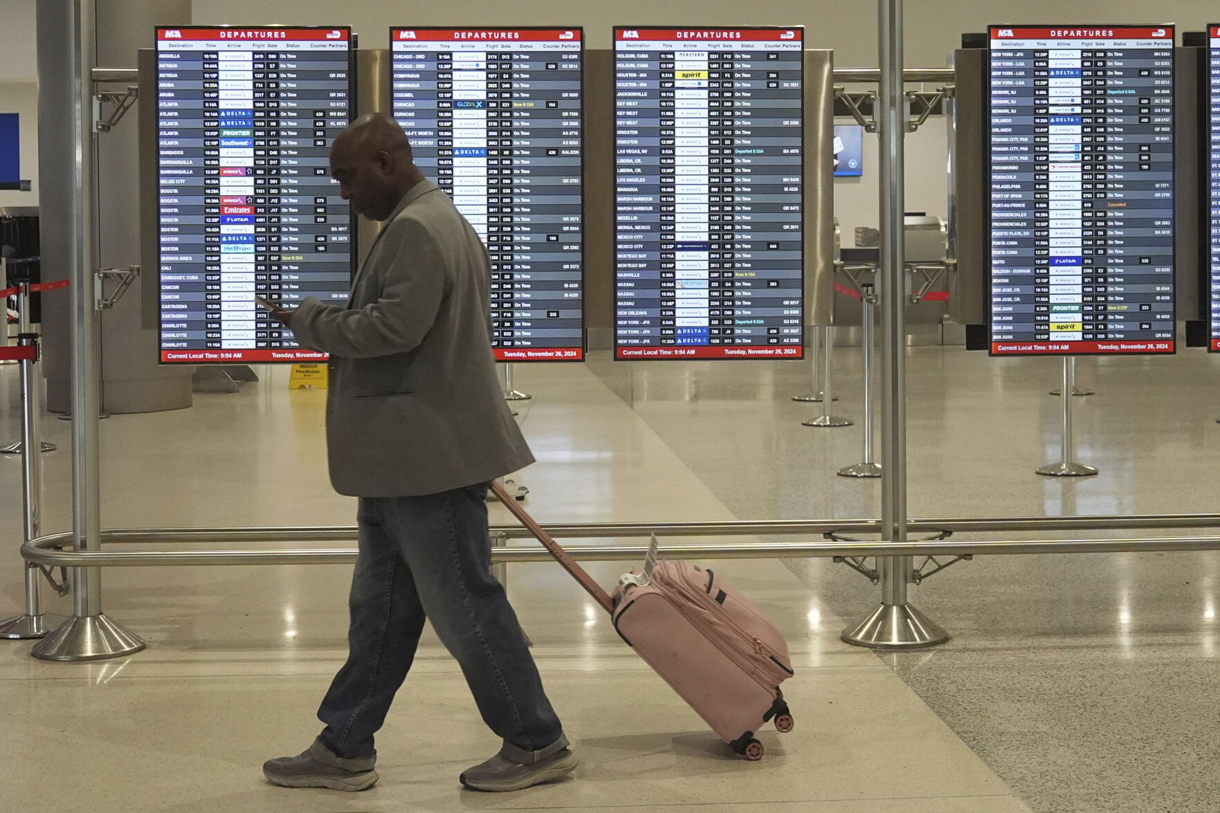 <p>A traveler walks to his gate at Miami International Airport, Tuesday, Nov. 26, 2024, in Miami. (AP Photo/Marta Lavandier)</p>   PHOTO CREDIT: Marta Lavandier - staff, ASSOCIATED PRESS