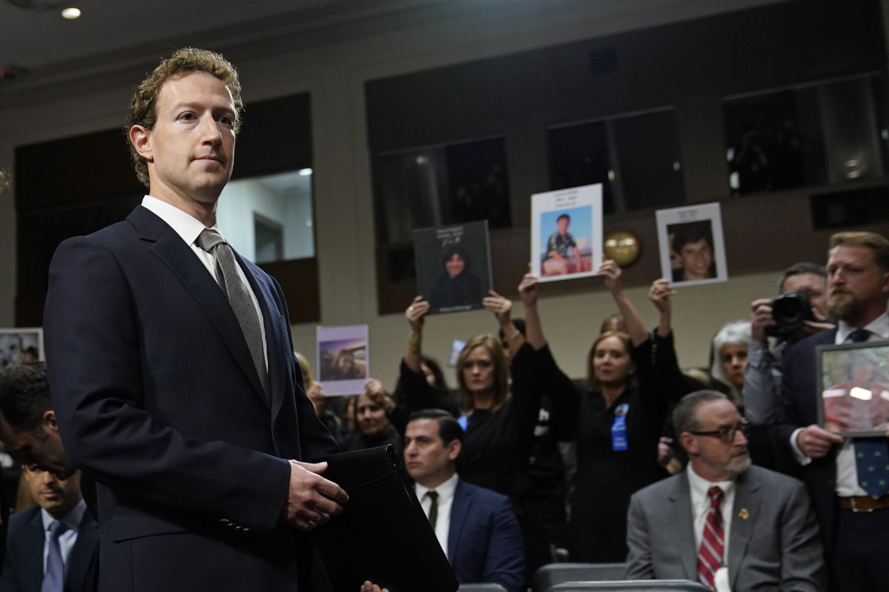 <p>FILE - With people holding photos of their loved ones, Meta CEO Mark Zuckerberg arrives to testify before a Senate Judiciary Committee hearing on Capitol Hill in Washington, Jan. 31, 2024, to discuss child safety. (AP Photo/Susan Walsh, File)</p>   PHOTO CREDIT: Susan Walsh - staff, ASSOCIATED PRESS