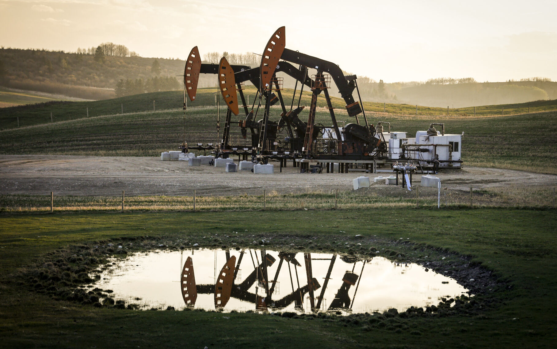 <p>FILE - Pumpjacks draw out oil and gas from well heads as wildfire smoke hangs in the air near Calgary, Alberta, May 12, 2024. (Jeff McIntosh/The Canadian Press via AP, File)</p>   PHOTO CREDIT: Jeff McIntosh 