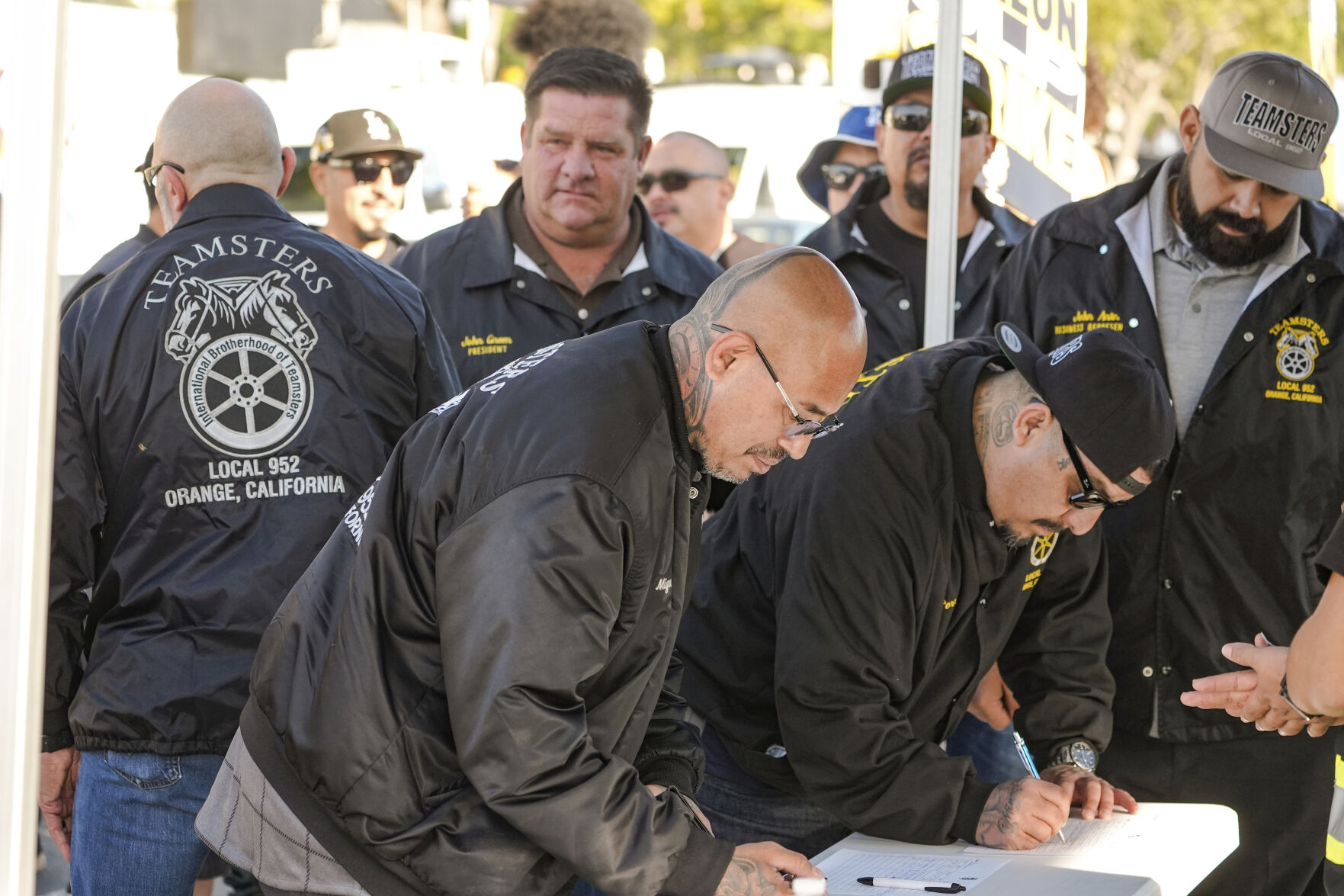 <p>Teamsters Local 952 members sign-in as they join Amazon workers striking outside the gates of an Amazon Fulfillment Center, Thursday, Dec. 19, 2024, in City of Industry, Calif. (AP Photo/Damian Dovarganes)</p>   PHOTO CREDIT: Damian Dovarganes - staff, ASSOCIATED PRESS