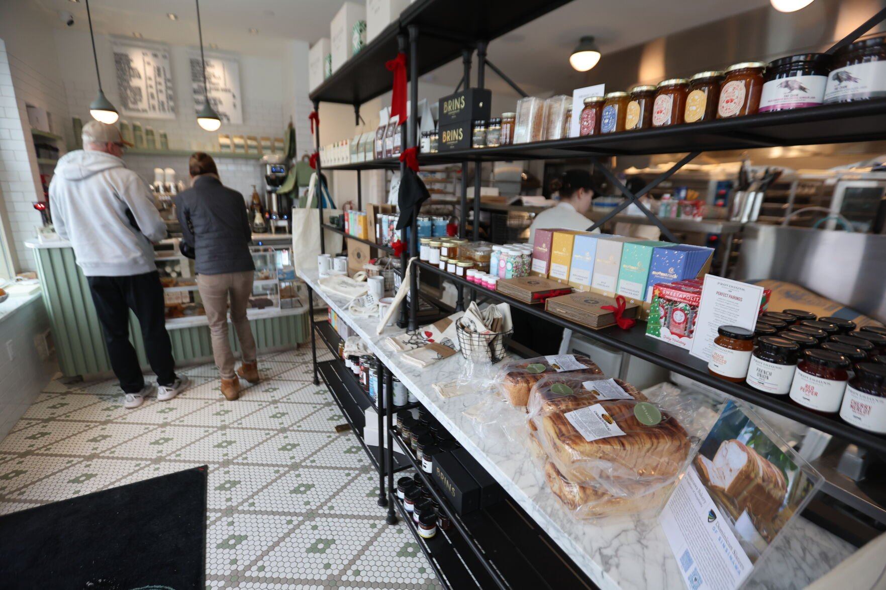 People shop inside Roux & Lucia bakery on Thursday. The bakery serves a variety of fresh breads and pastries, including Sinsinawa cinnamon bread.    PHOTO CREDIT: Dave Kettering