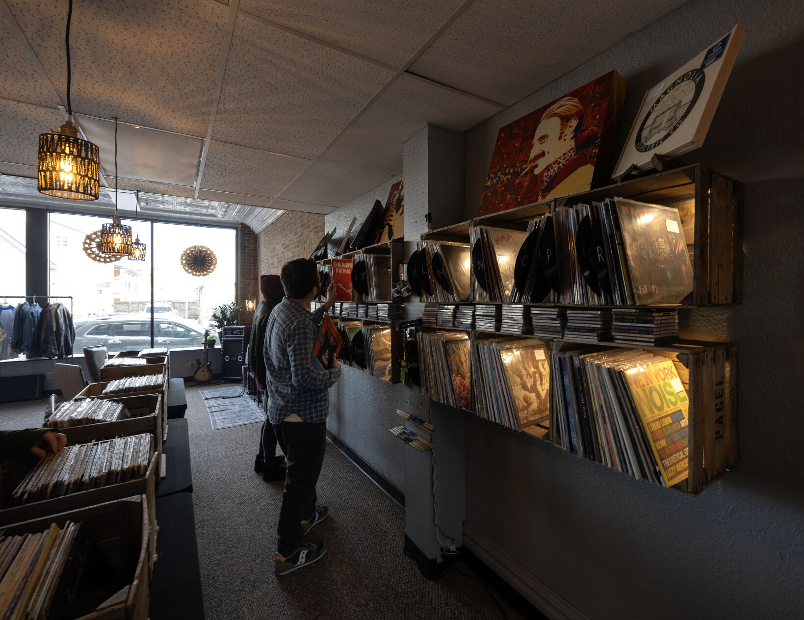 Customers browse through the vinyl records at Ruix Records in Dubuque on Friday.    PHOTO CREDIT: Gassman