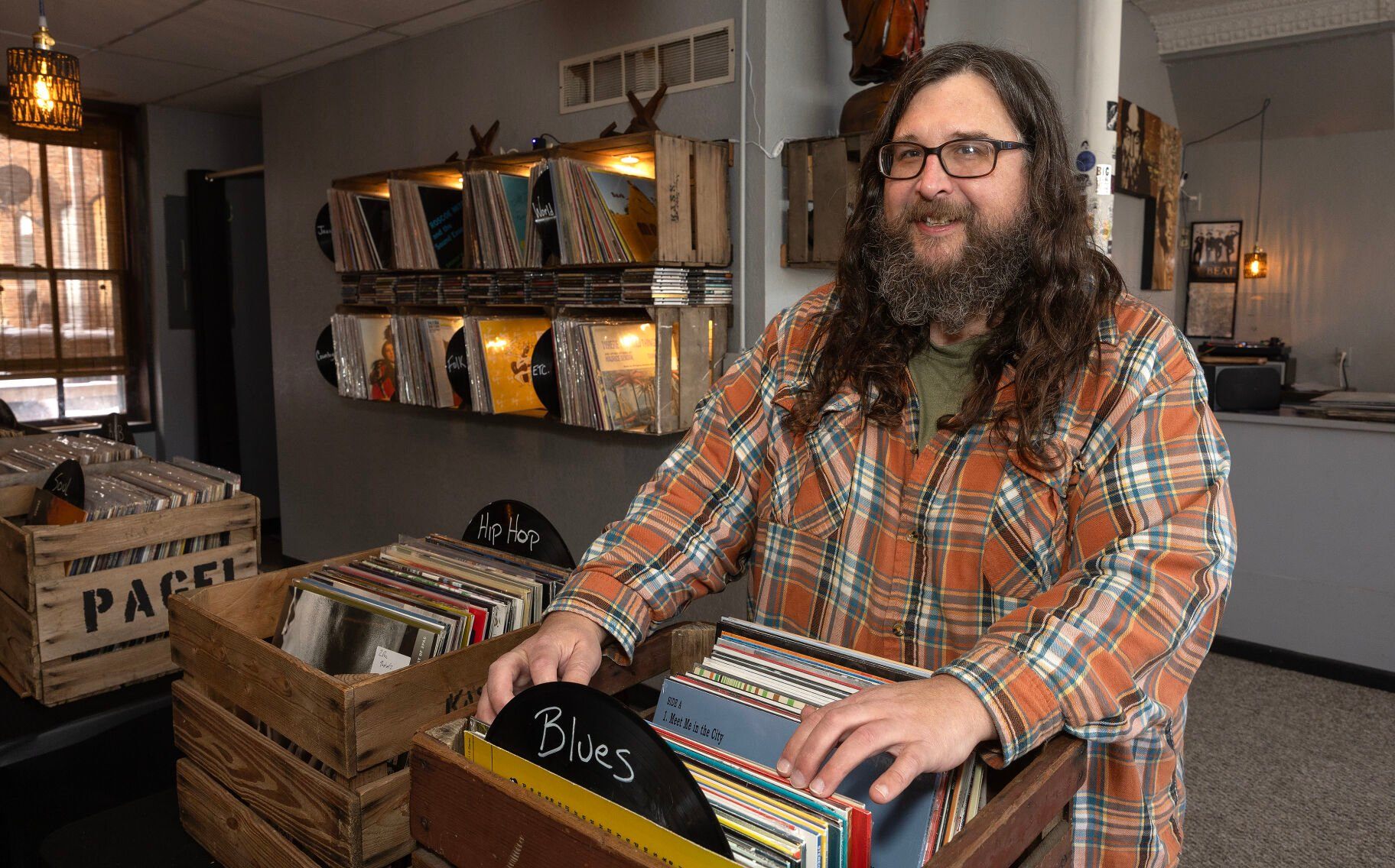 Co-owner Bob Bucko sorts vinyl records at Ruix Records in Dubuque on Friday.    PHOTO CREDIT: Gassman