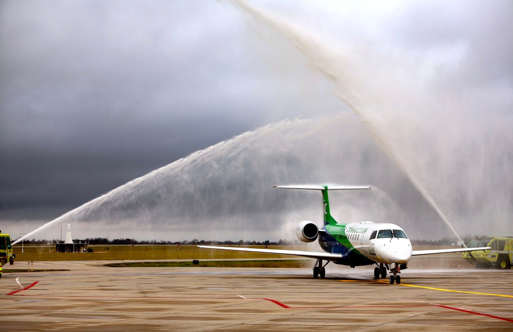 Water cannons shoot over the first flight of Denver Air Connection from Chicago to Dubuque as it taxis to Capt. Robert L. Martin Terminal at Dubuque Regional Airport on Nov. 4.    PHOTO CREDIT: TH file