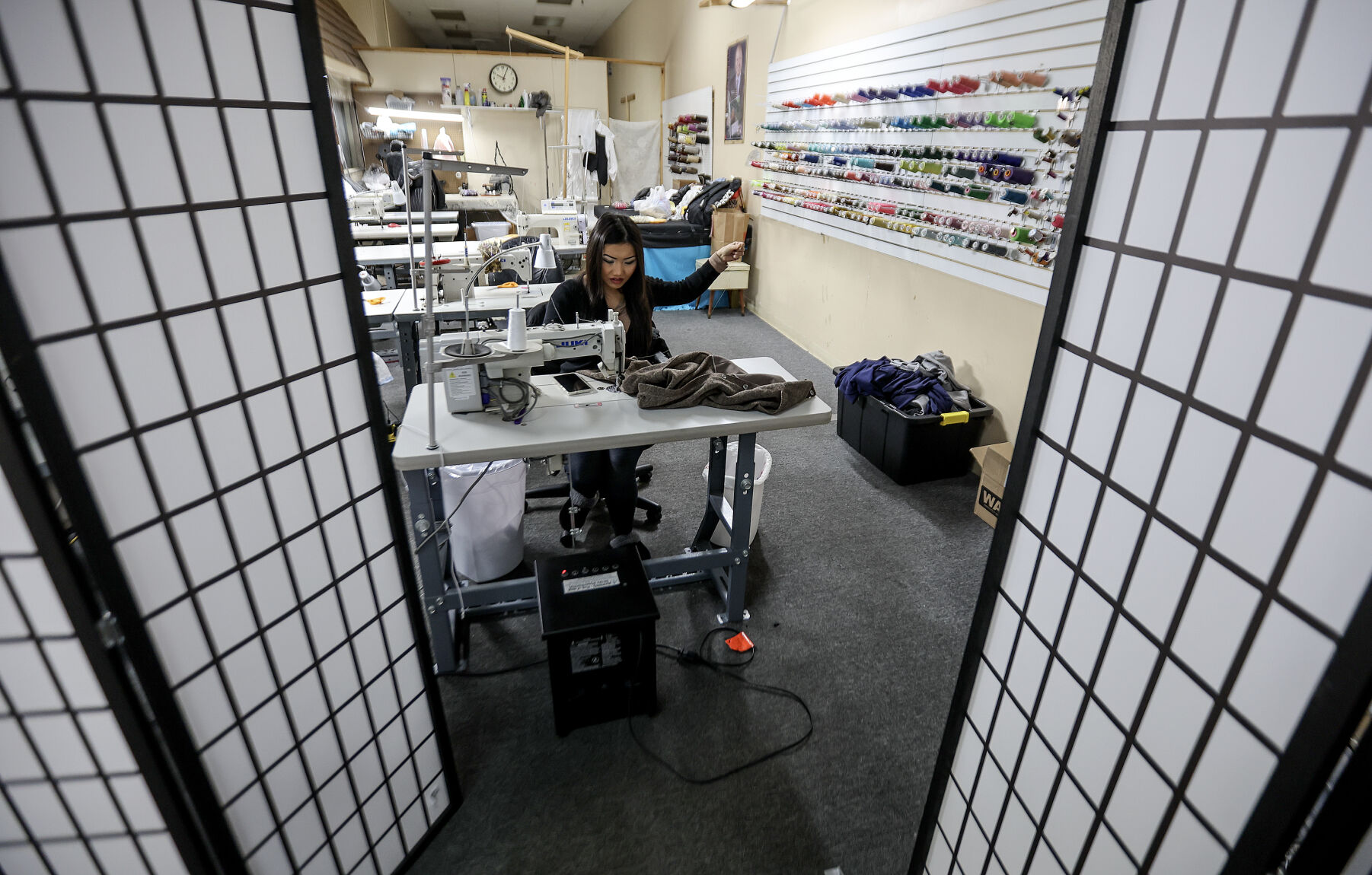 Xai Xiong, co-owner of Suns Alterations, works at the business in Kennedy Mall.    PHOTO CREDIT: Dave Kettering
Telegraph Herald