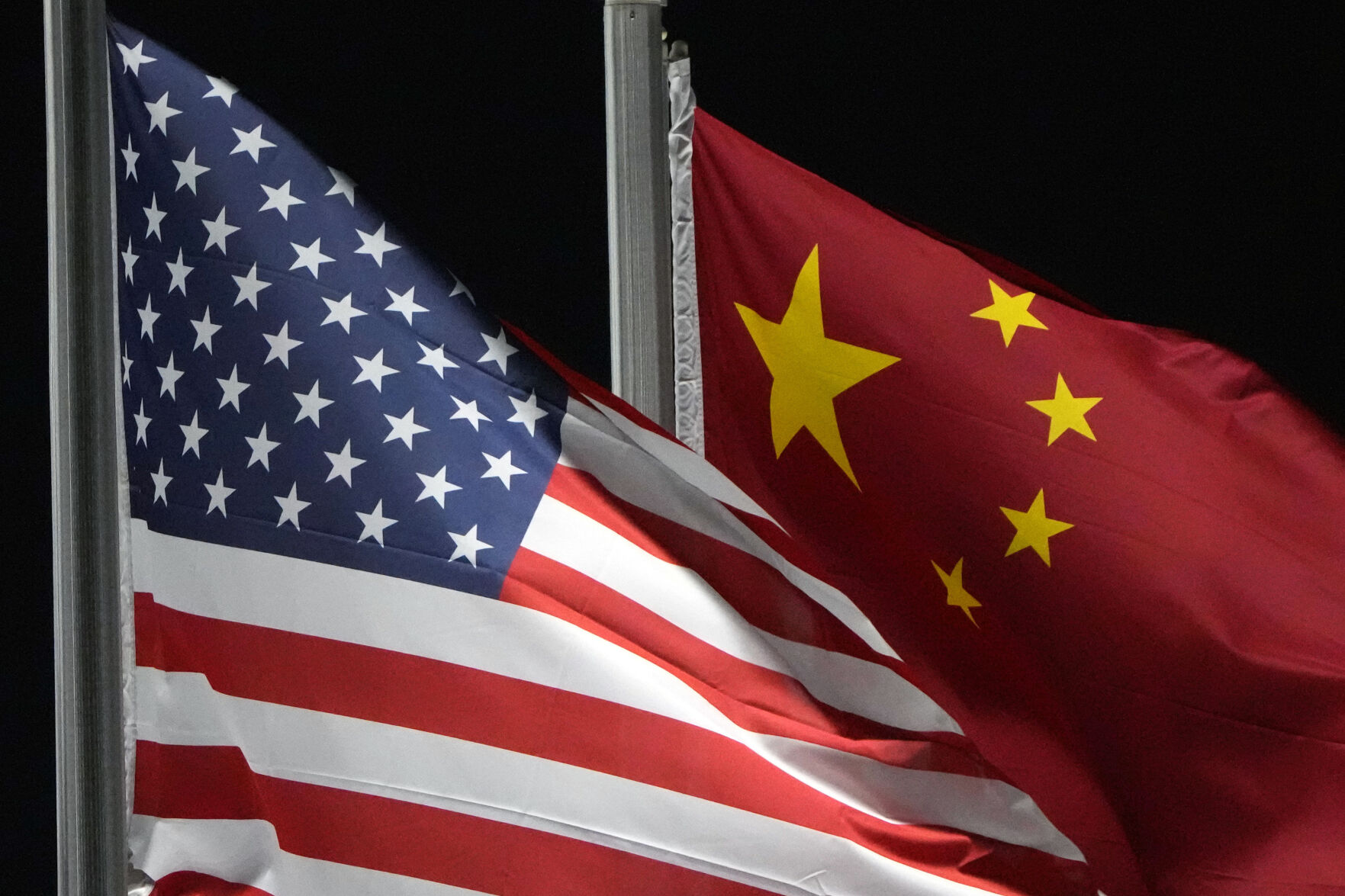 <p>FILE - The American and Chinese flags wave at Genting Snow Park ahead of the 2022 Winter Olympics, Feb. 2, 2022, in Zhangjiakou, China. (AP Photo/Kiichiro Sato, File)</p>   PHOTO CREDIT: Kiichiro Sato 