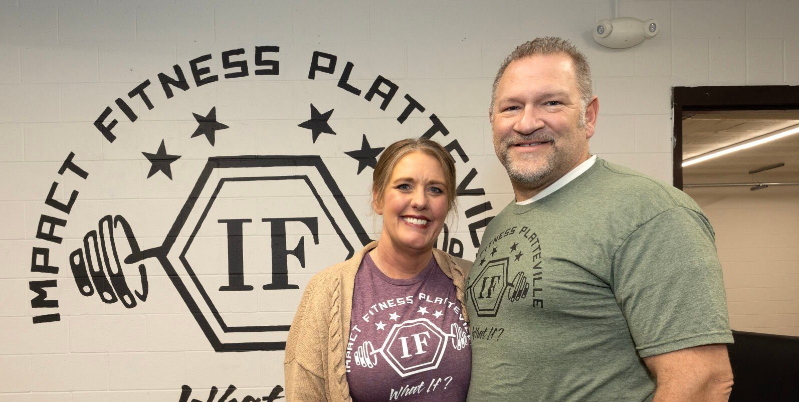 Owner Christina Sonsalla and her husband, Drew, pose at Impact Fitness in Platteville, Wis., on Thursday.    PHOTO CREDIT: Gassman