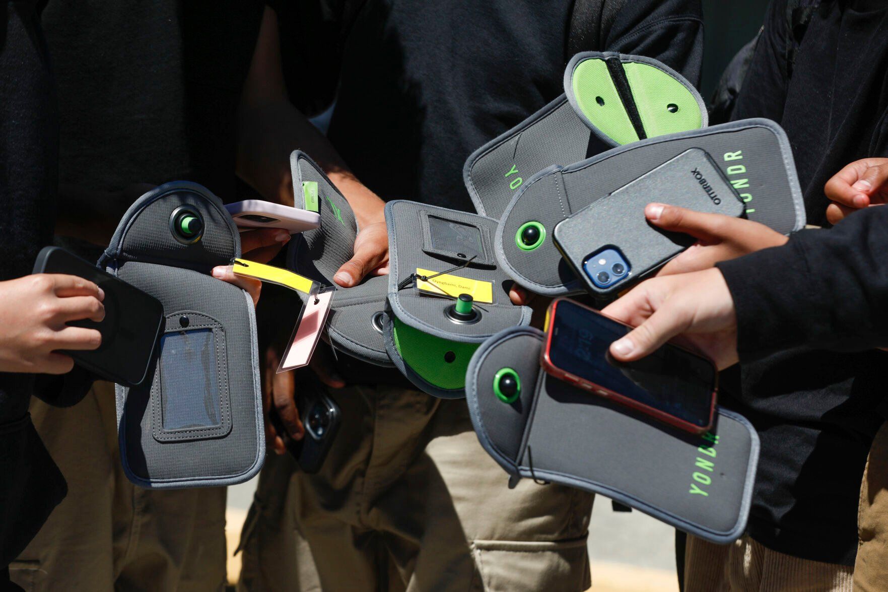 <p>FILE - A student uses a cell phone after unlocking the pouch that secures it from use during the school day at Bayside Academy, Aug. 16, 2024, in San Mateo, Calif. (Lea Suzuki/San Francisco Chronicle via AP, File)</p>   PHOTO CREDIT: Lea Suzuki